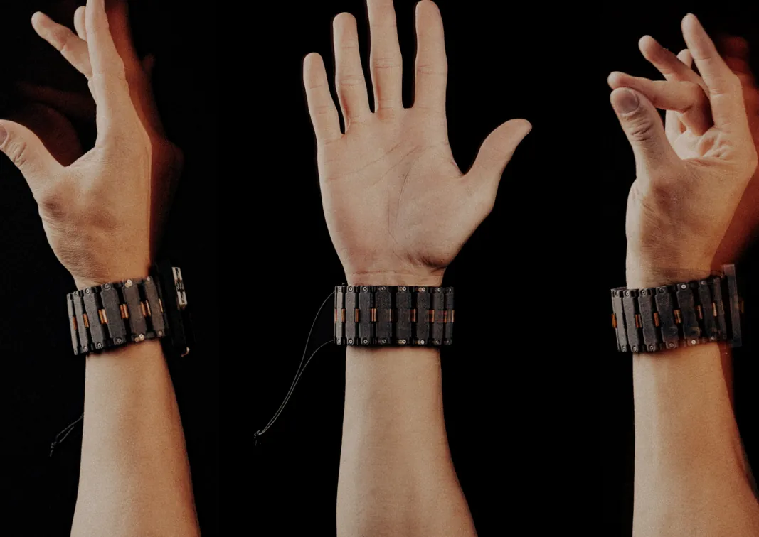 The chain-link Roam band prototype worn on three wrists making different hand gestures
