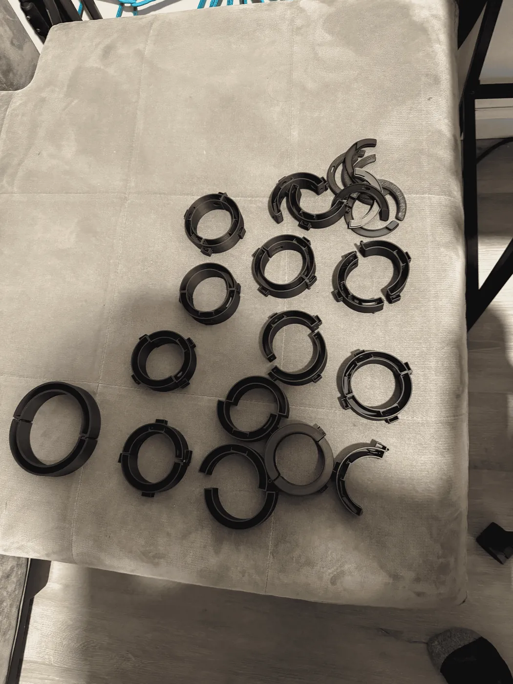 A table covered in 3D-printed band prototypes from successive design iterations