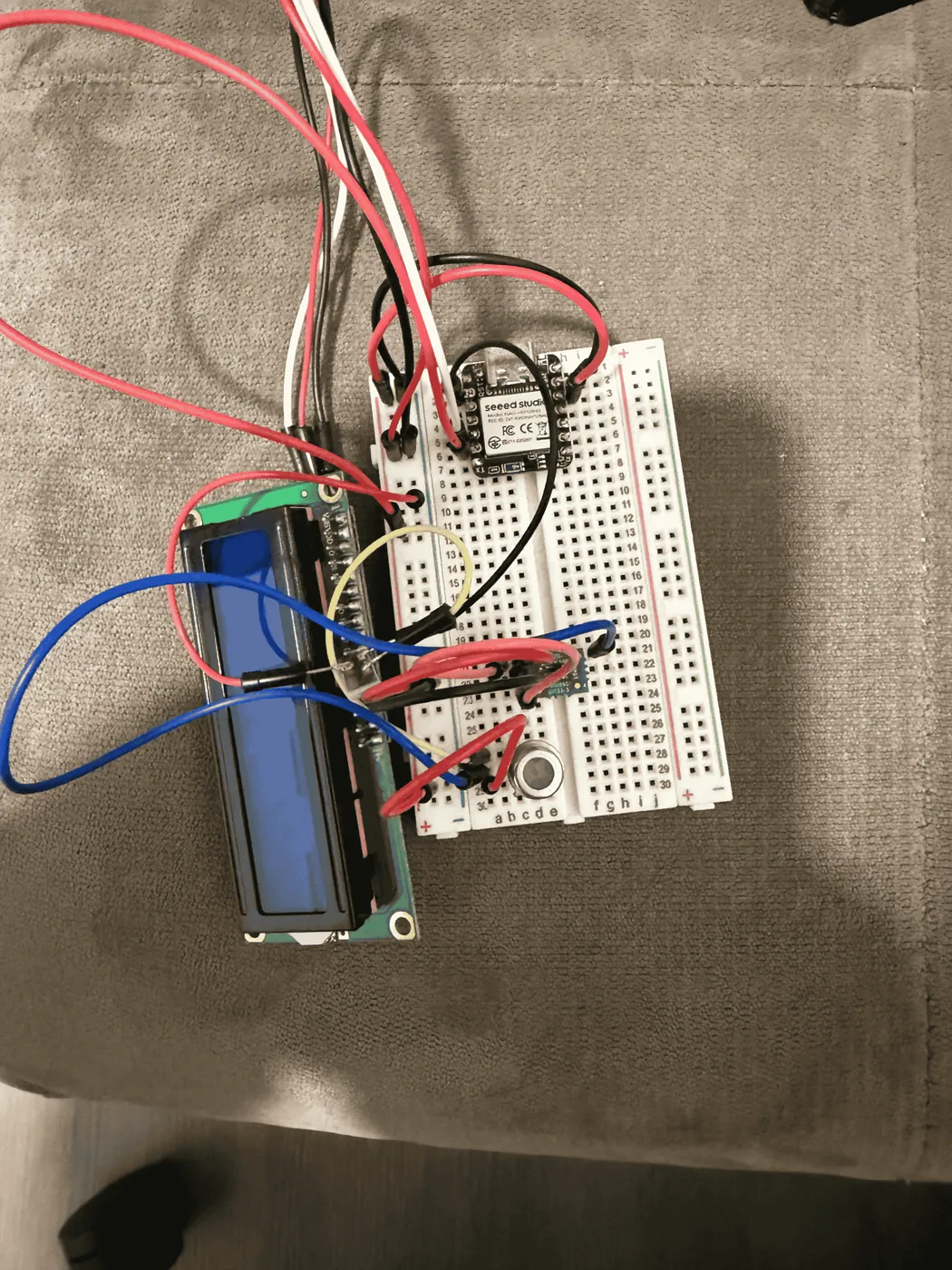 Breadboard test rig with sensor wiring and a small display used for calibration